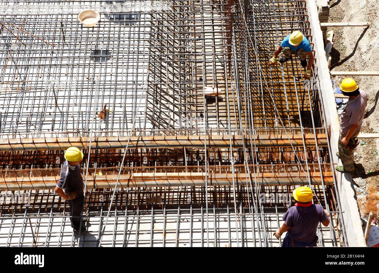 worker in the construction site making reinforcement metal framework ...