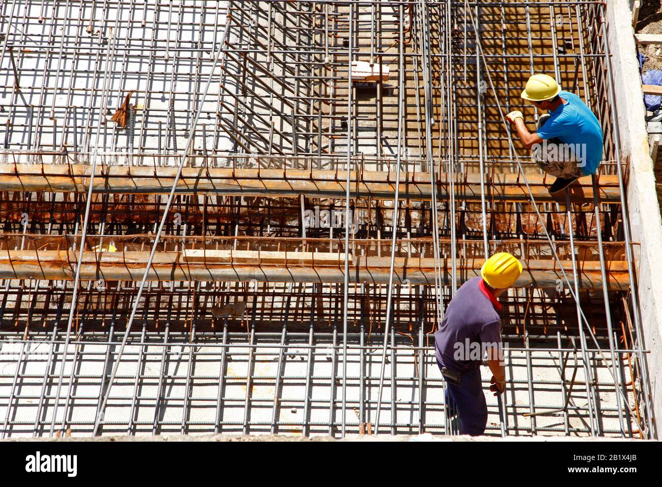 worker in the construction site making reinforcement metal framework ...