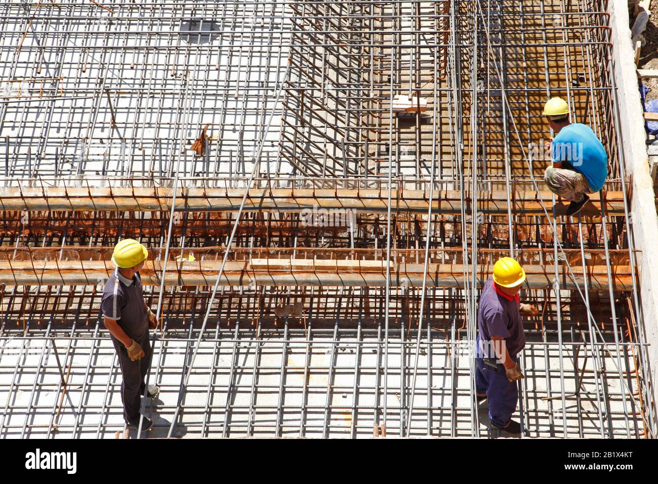 worker in the construction site making reinforcement metal framework ...