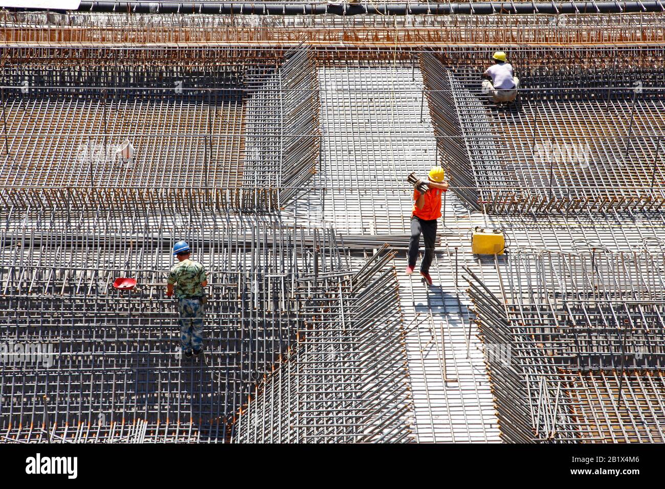 worker in the construction site making reinforcement metal framework ...