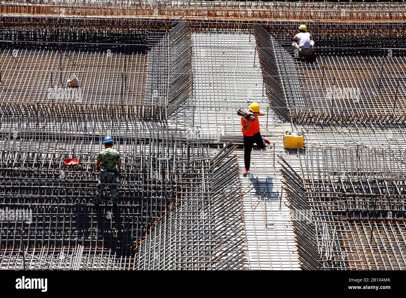 worker in the construction site making reinforcement metal framework ...