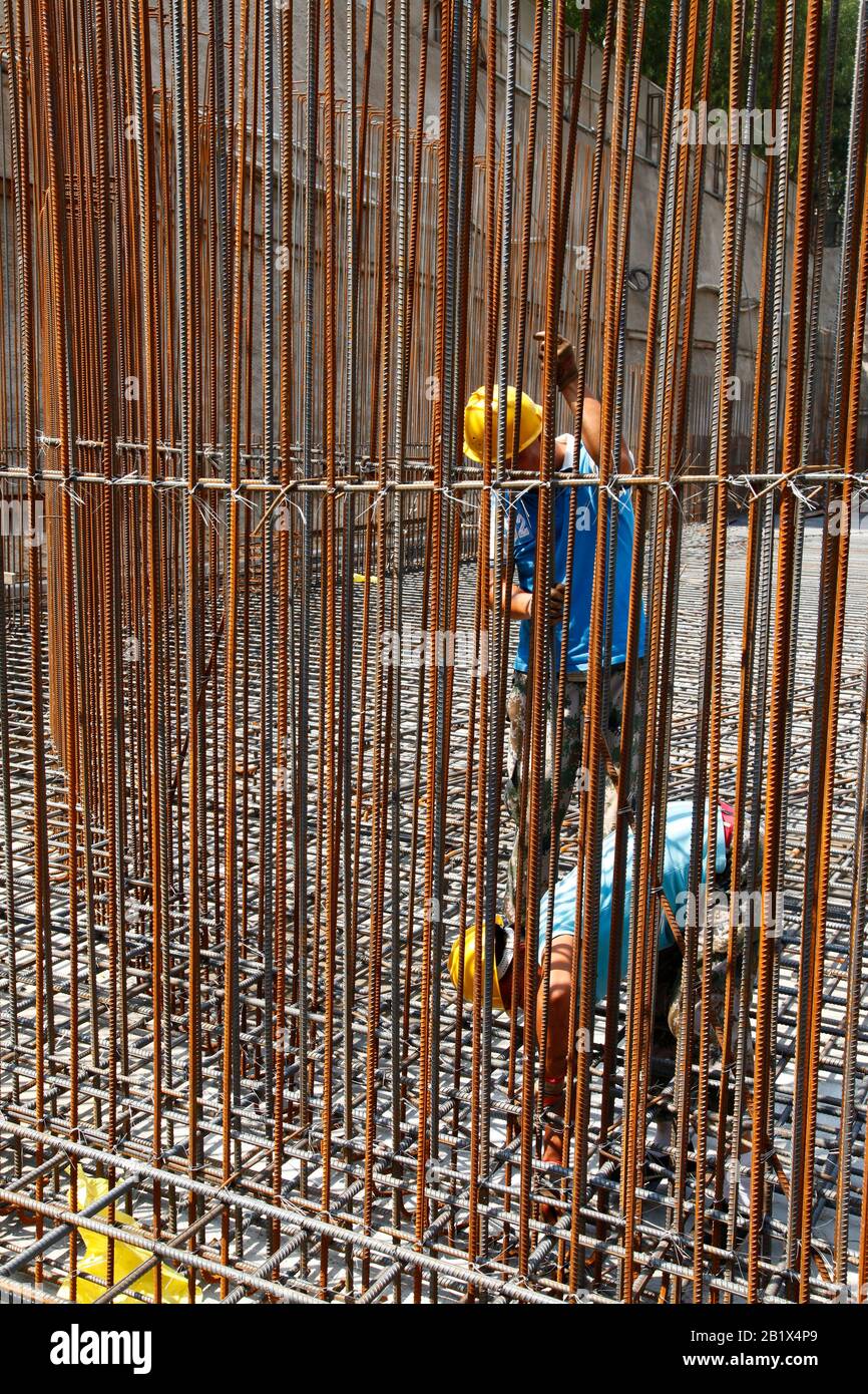 worker in the construction site making reinforcement metal framework ...