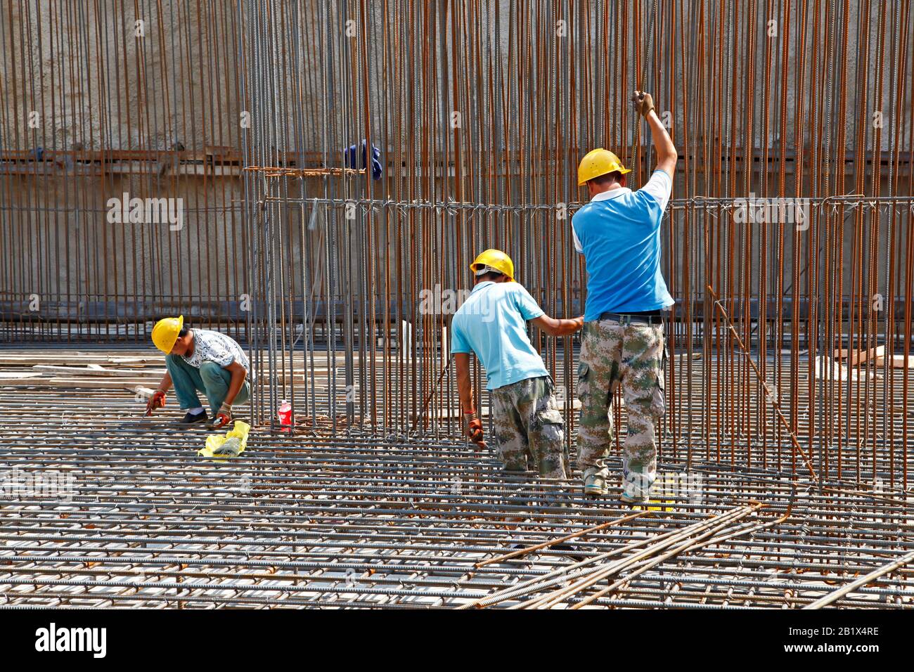 worker in the construction site making reinforcement metal framework ...