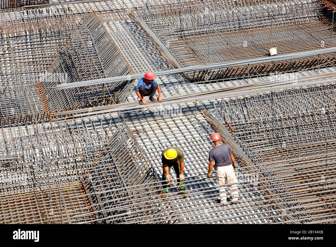 worker in the construction site making reinforcement metal framework ...
