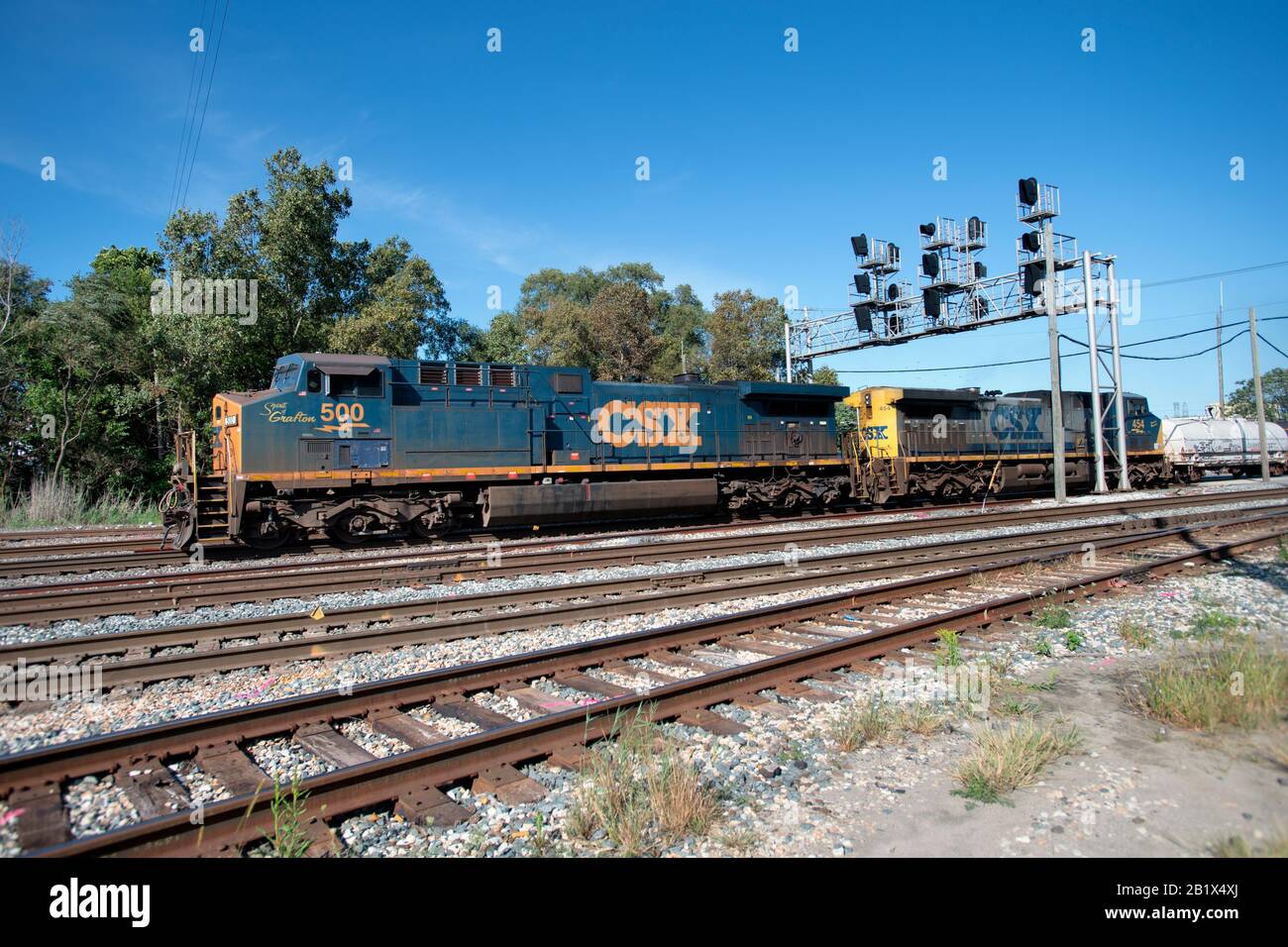 Dolton, Illinois, USA. A CSX (CSX Transportation) freight train moving on a busy multi-track route and under a signal tower. Stock Photo