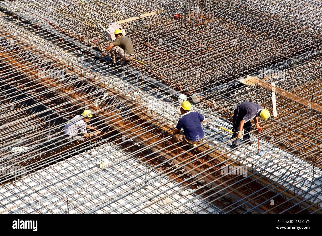 worker in the construction site making reinforcement metal framework ...