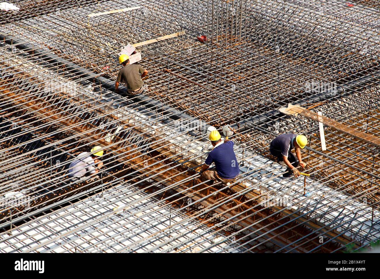 worker in the construction site making reinforcement metal framework ...