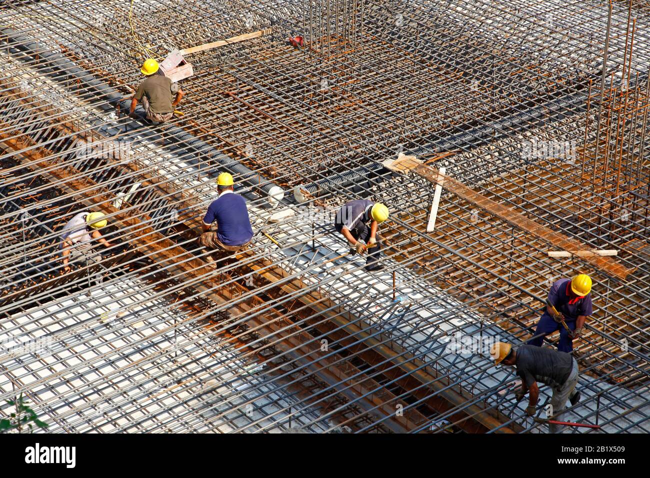worker in the construction site making reinforcement metal framework ...