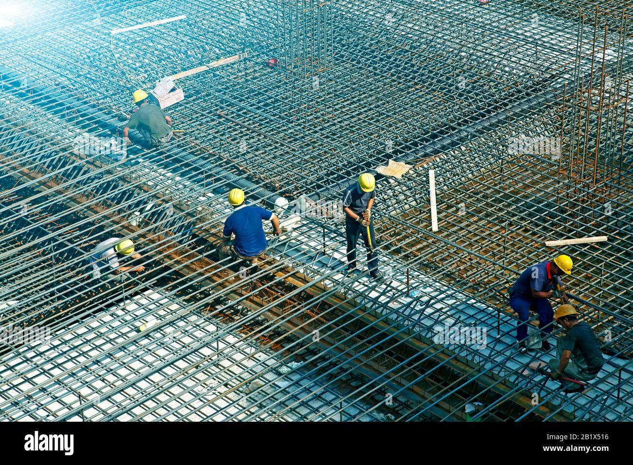 worker in the construction site making reinforcement metal framework ...