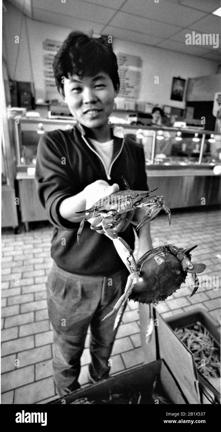 Asian woman selling crabs an other fresh quality sea foods in China town in LA Cal Stock Photo