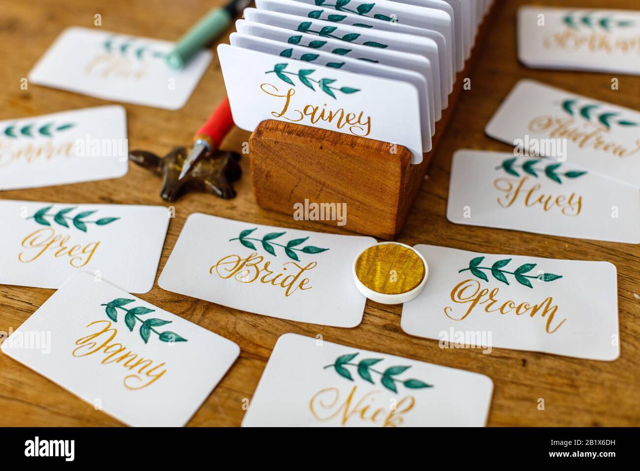 Wedding calligraphy handwritten place cards with names. Golden