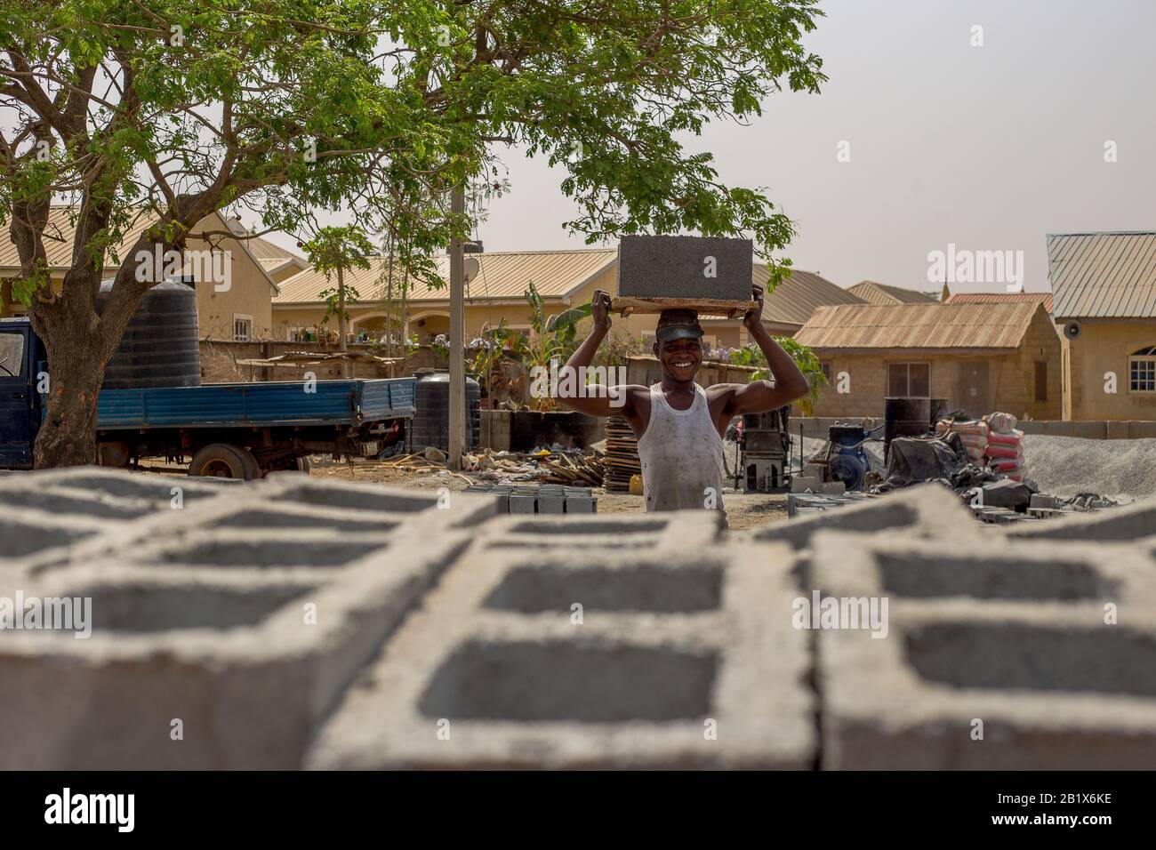 A man lay out bricks at a factory in Abuja, Nigeria. Stock Photo