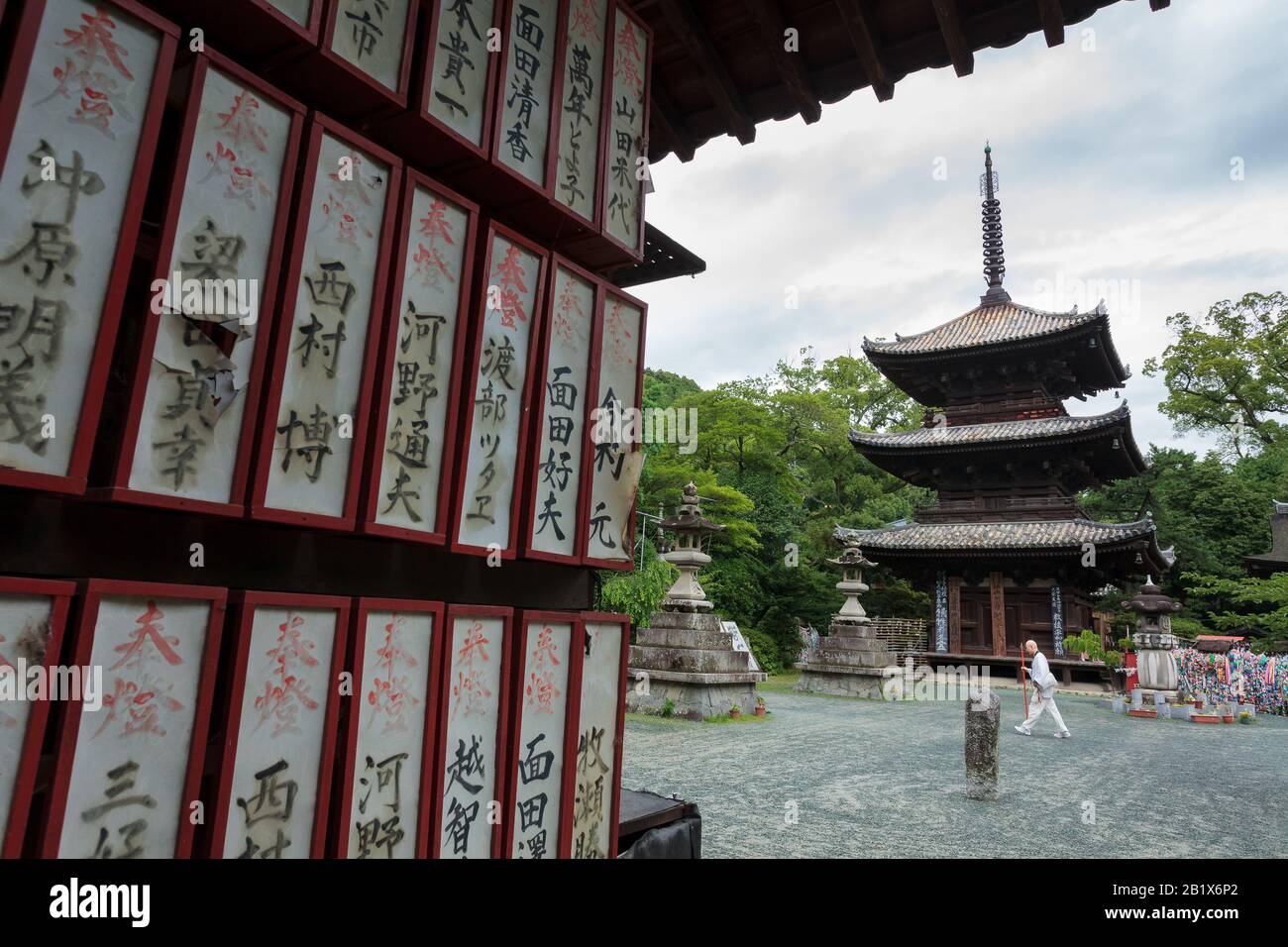 A Pilgrim, known as a Henro, enters Ishite temple on the Shikoku 88 Temple pilgrimage, Matsuyama, Eihime, Japan. Stock Photo