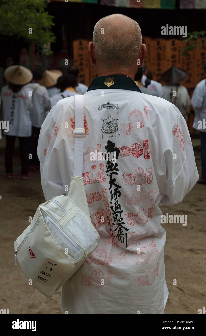 Pilgrims, known as a Henro, pray at shite temple on the Shikoku 88 Temple pilgrimage, Matsuyama, Eihime, Japan.. Stock Photo