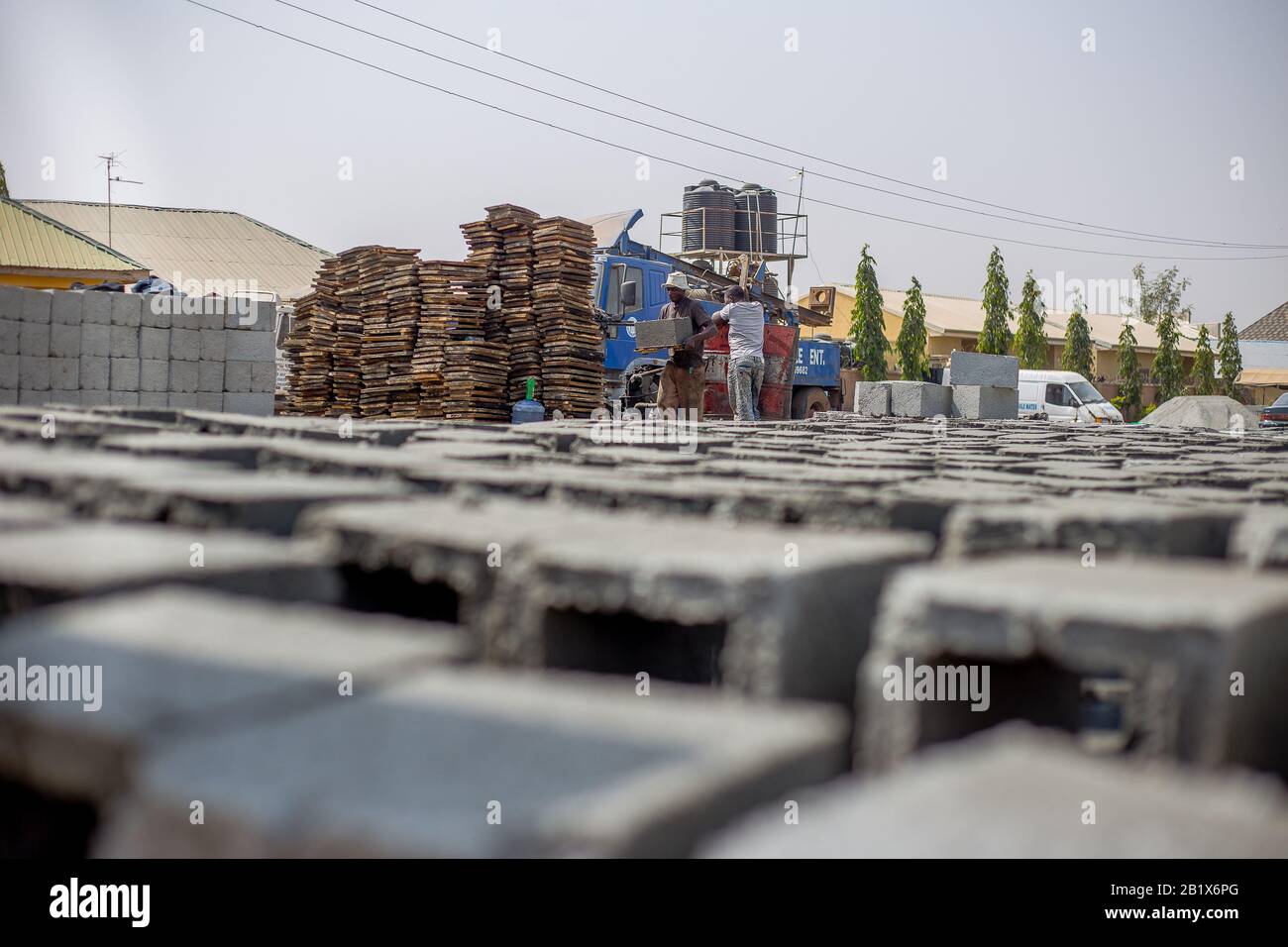 A man lay out bricks at a factory in Abuja, Nigeria. Stock Photo