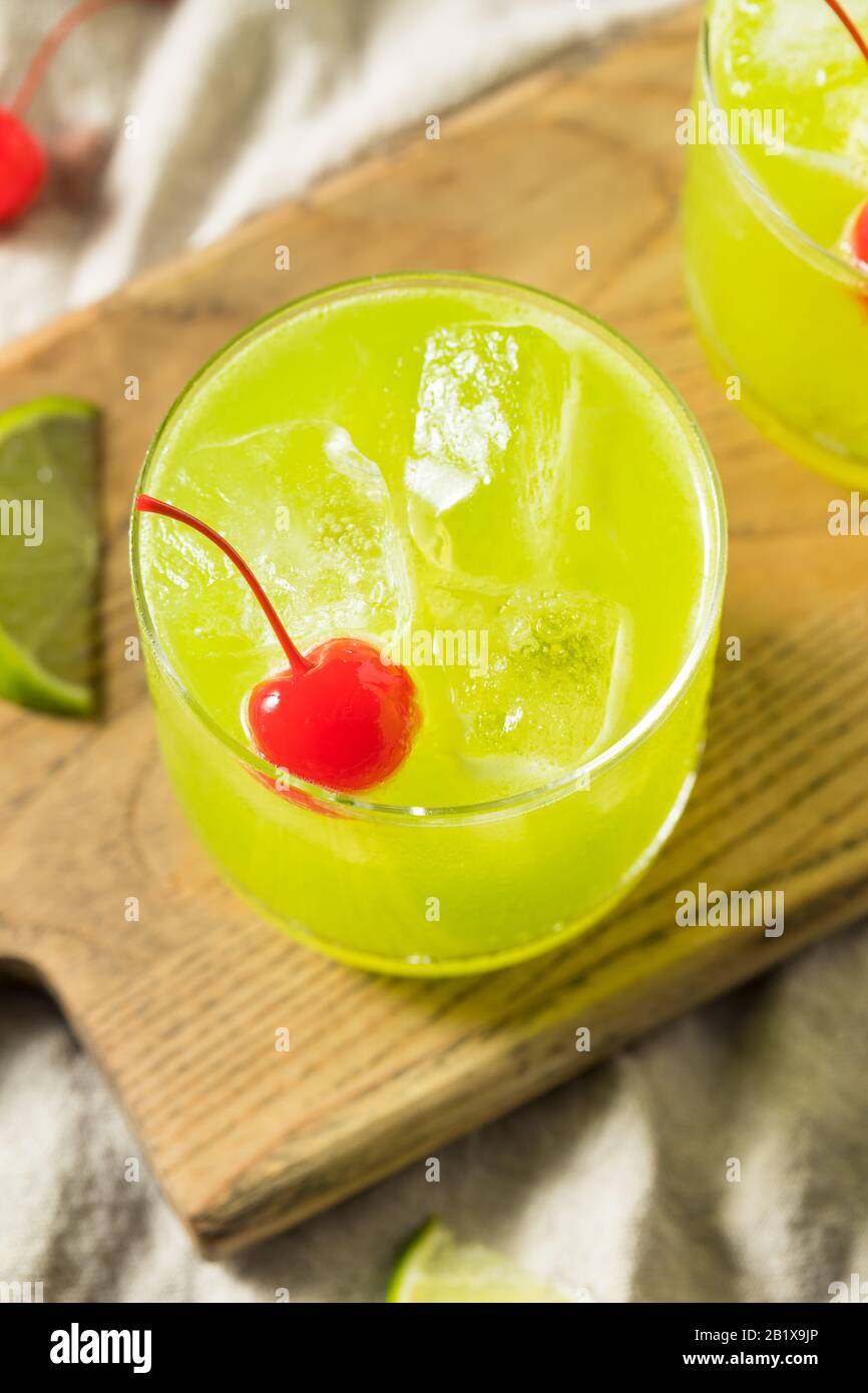 Homemade Green Melon Midori Sour with a Red Cherry Stock Photo Alamy