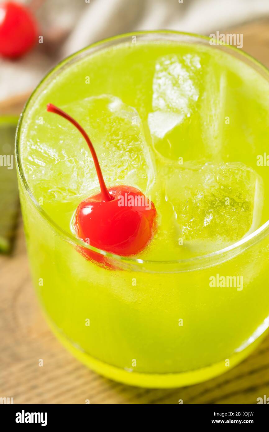 Homemade Green Melon Midori Sour with a Red Cherry Stock Photo