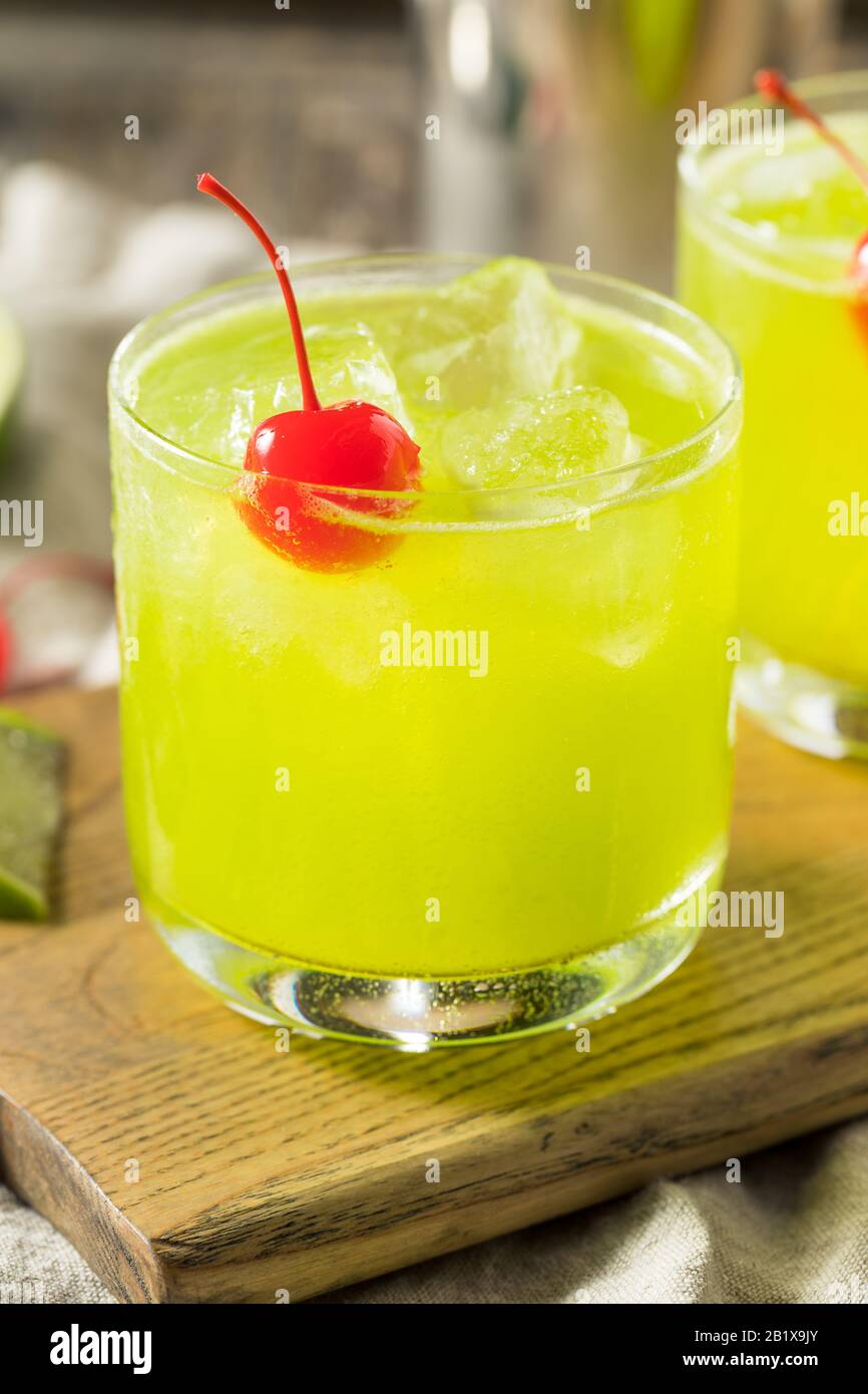 Homemade Green Melon Midori Sour with a Red Cherry Stock Photo