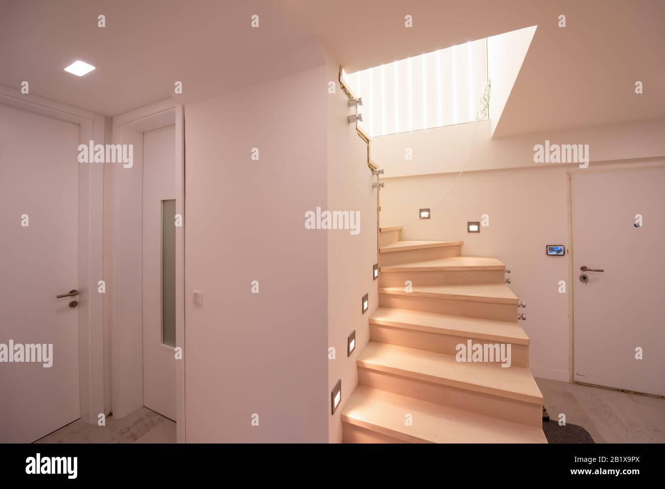 Picture Idea: Stylish Interior With Wooden Stairs In Big Modern Two Level