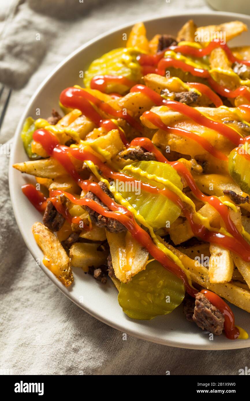 Homemade Loaded Cheeseburger Cheese Fries with PIckles and Ketchup Stock Photo Alamy