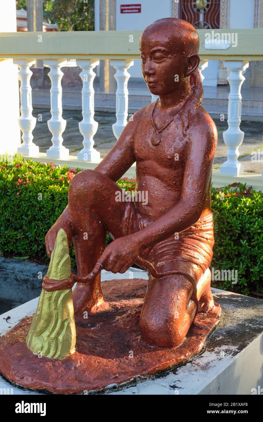 At Wat Phra Thong, Phuket, Thailand, a figure retells the legend of the discovery of the temple's Buddha statue buried deep in the ground Stock Photo