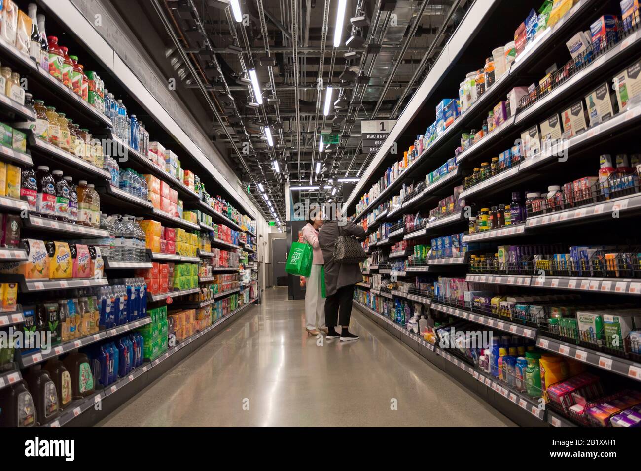 Customers shop at Amazon Go Grocery on February 27, 2020. The tech  company's first full-size cashierless supermarket opened in Seattle's  Capitol Hill neighborhood earlier in the week. Customers scan an Amazon Go