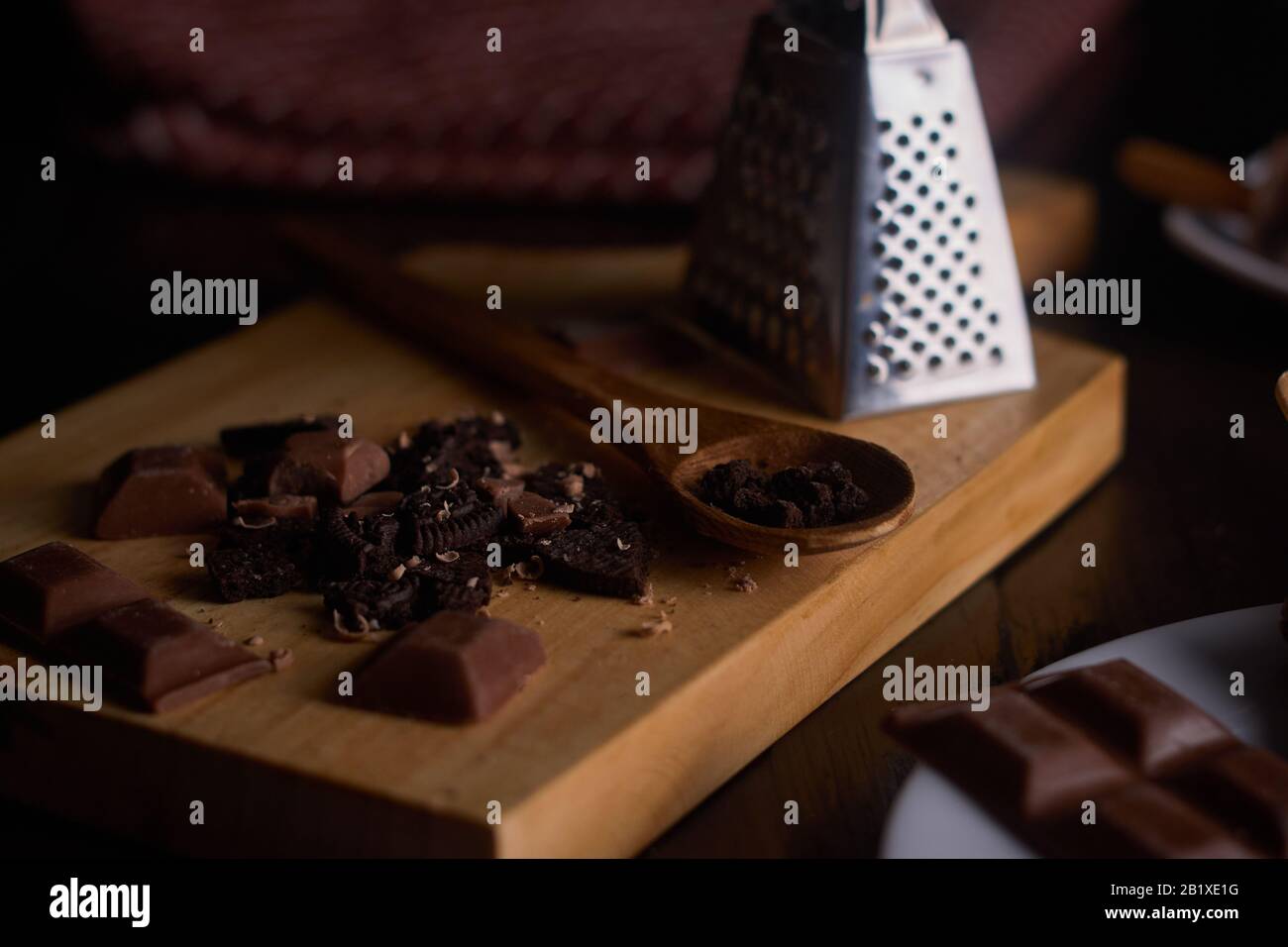 Chocolate chip pieces with chocolate pieces on cutting board with wooden spoon Stock Photo