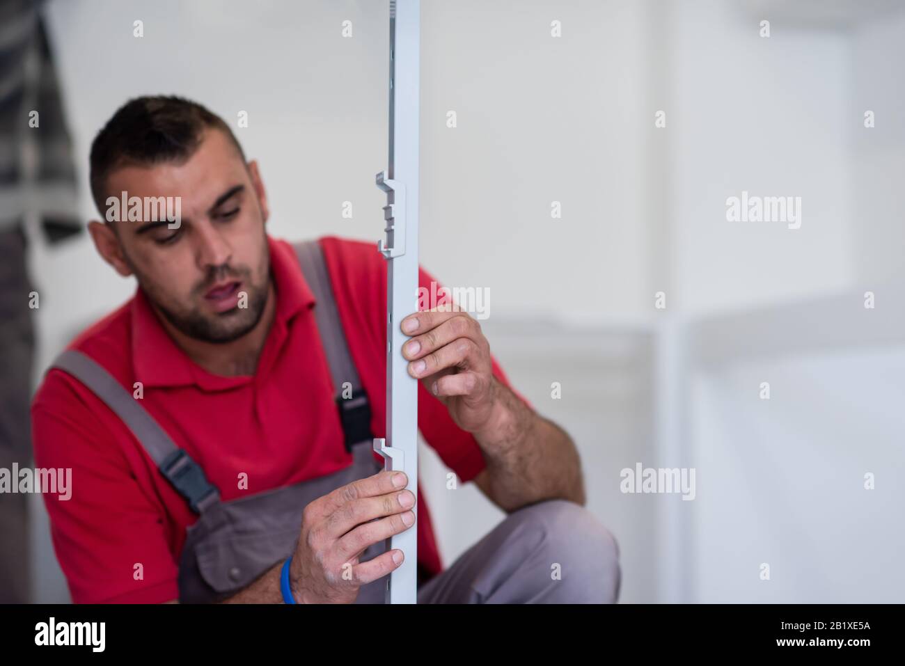 young professional worker installing a new stylish modern kitchen furniture Stock Photo