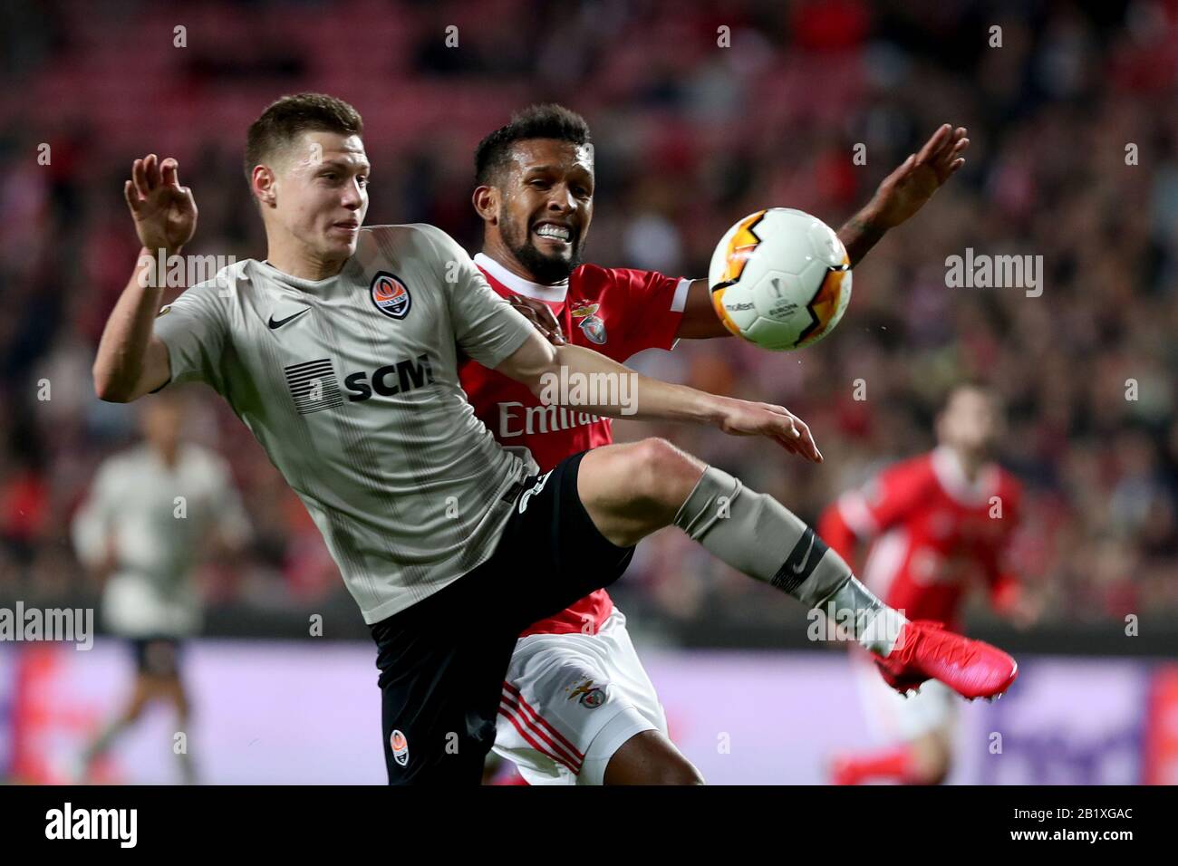 Lisbon, Portugal. 27th Feb, 2020. Mykola Matvienko of Shakhtar Donetsk (L) vies with Dyego Sousa of SL Benfica during the UEFA Europa League round of 32 second leg football match between SL Benfica and Shakhtar Donetsk in Lisbon, Portugal, on Feb. 27, 2020. Credit: Pedro Fiuza/Xinhua/Alamy Live News Stock Photo