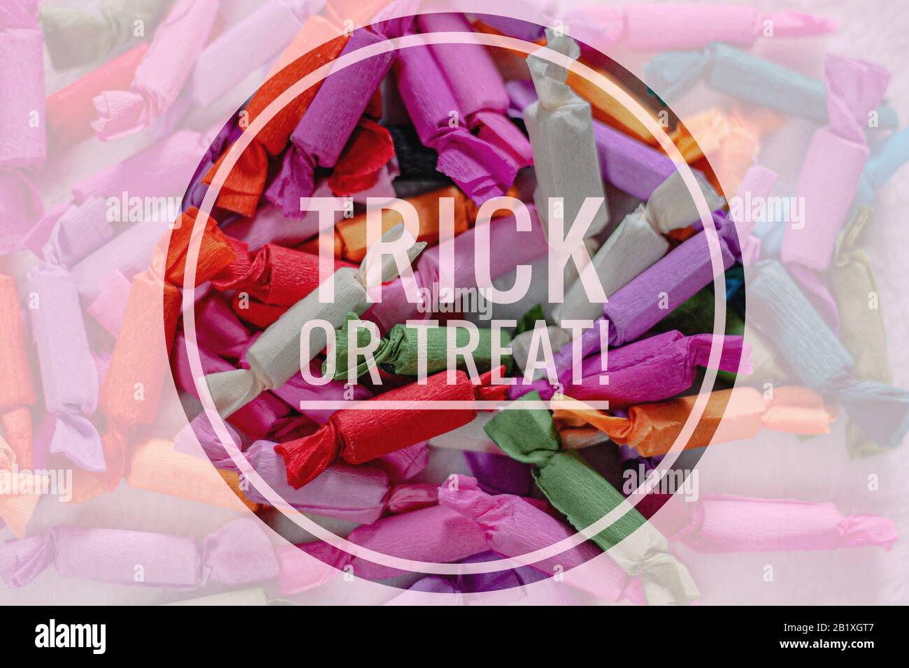 Trick or Treat Halloween Typography Background against colorful wrapped candy treats Stock Photo
