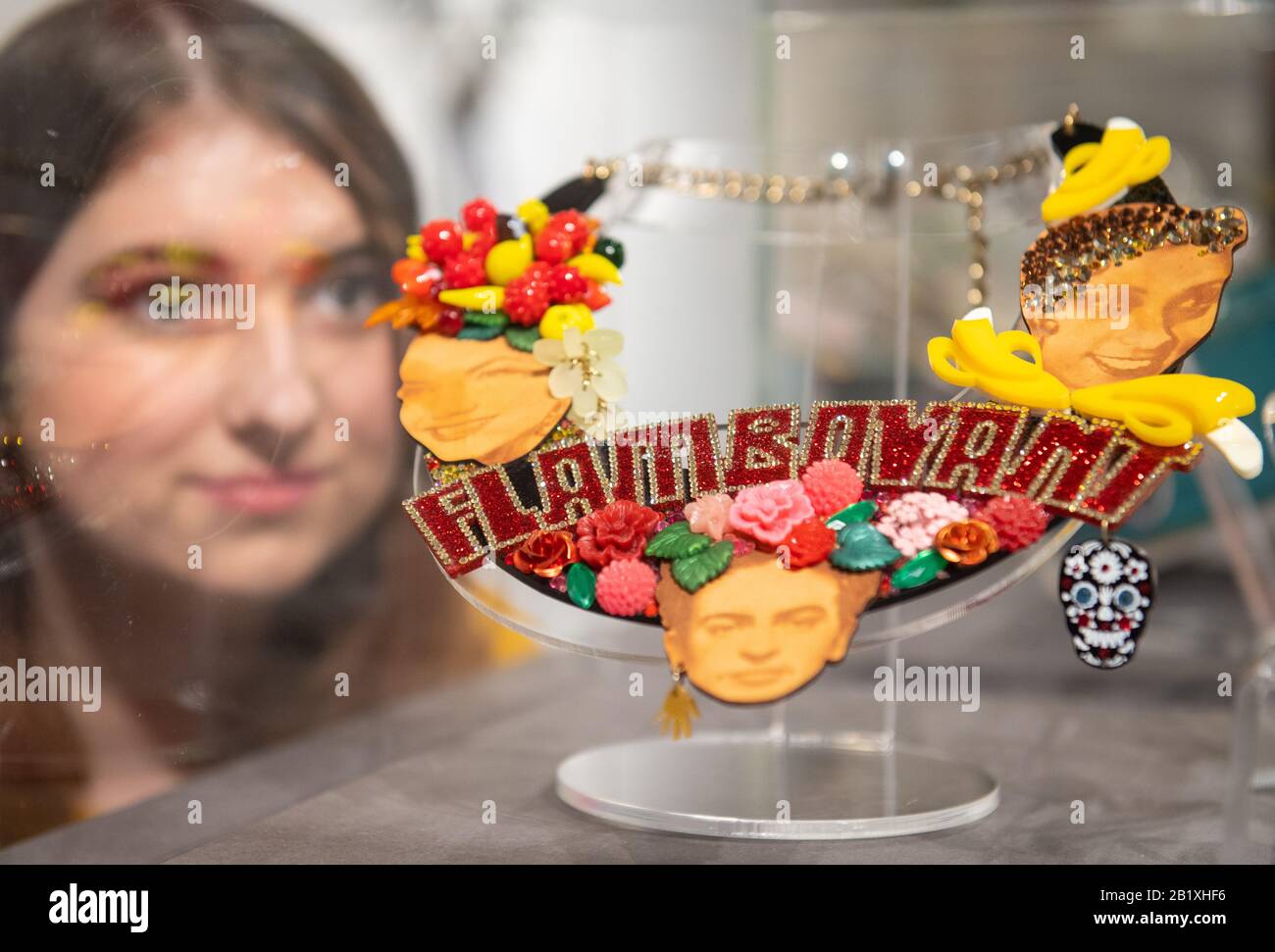 Ruth Davies-Mourby views a Tatty Devine laser-cut acrylic Flamboyant necklace, part of the 'Misshapes: the Making of Tatty Devine' exhibition, which features over 100 pieces from 20 years of the iconic British jewellery brand, at the Stephen Lawrence Gallery in London. Stock Photo