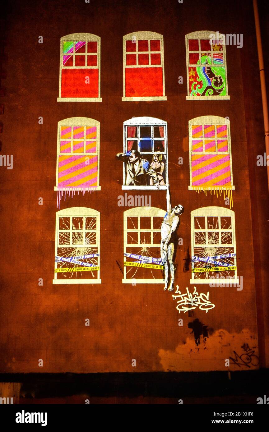 Light projections sit around a graffiti piece by Banksy (centre) on Park Street, Bristol, to create a new work of art titled Neighbours, to pay homage to the city’s graffiti culture, which has been created by collection of Bristol artists as part of the first ever Bristol Light Festival. Stock Photo