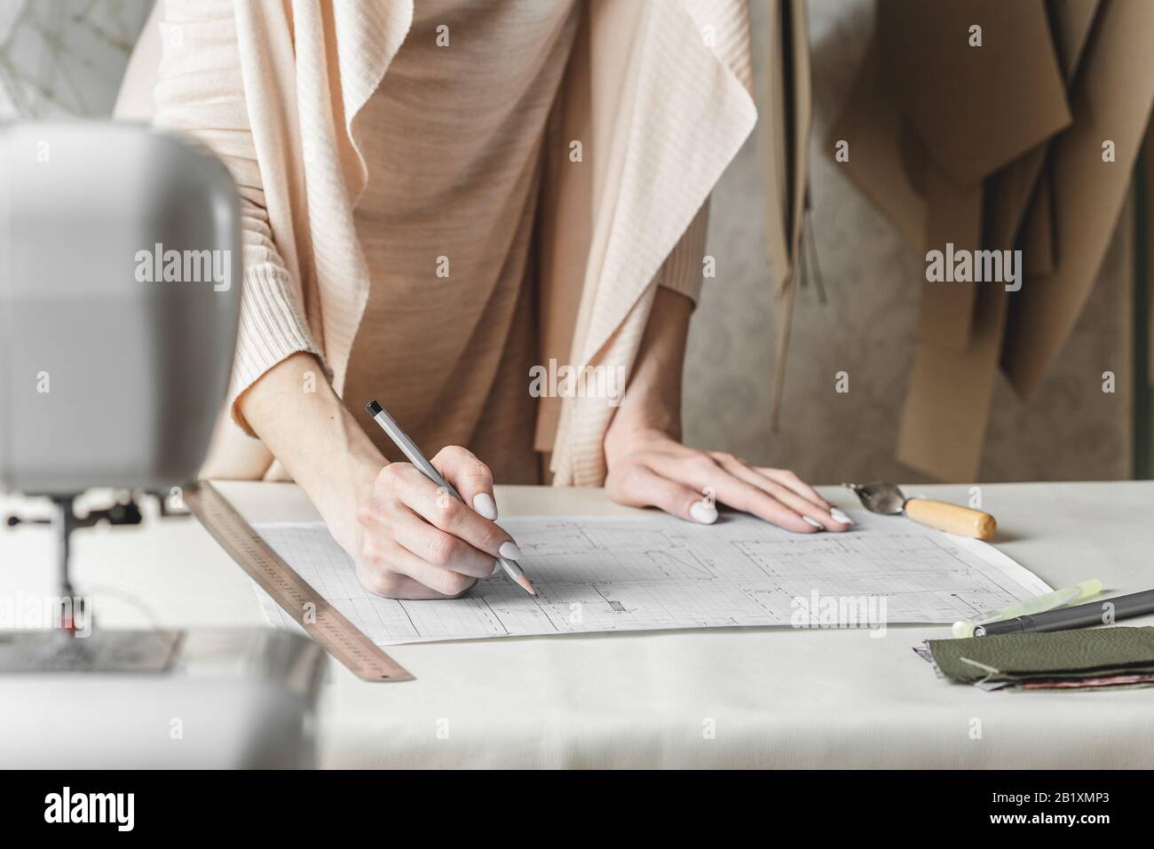 Woman fashion designer created sewing pattern for leather detail close up Stock Photo