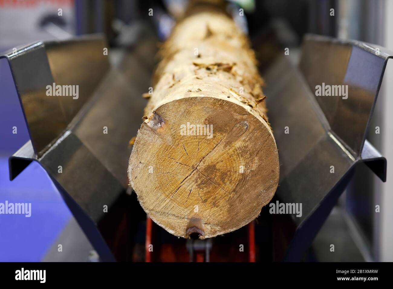 Wood log peeling with a debarker machine. Selective focus. Stock Photo