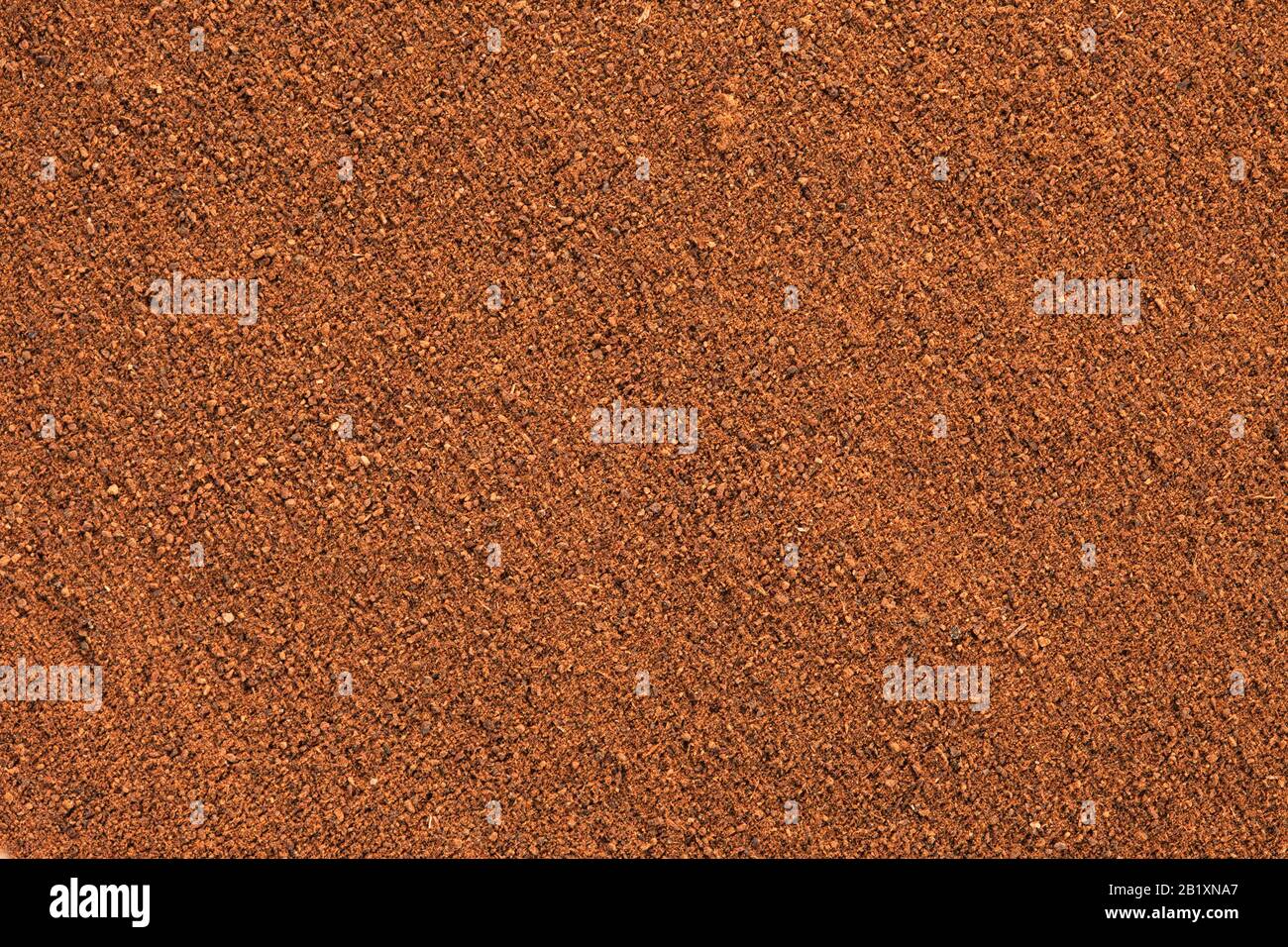 Ground Cinnamon texture, full frame background.  As a spice or condiment cinnamon sold in the form of sticks or a hammer. Used as a spice in cuisines Stock Photo