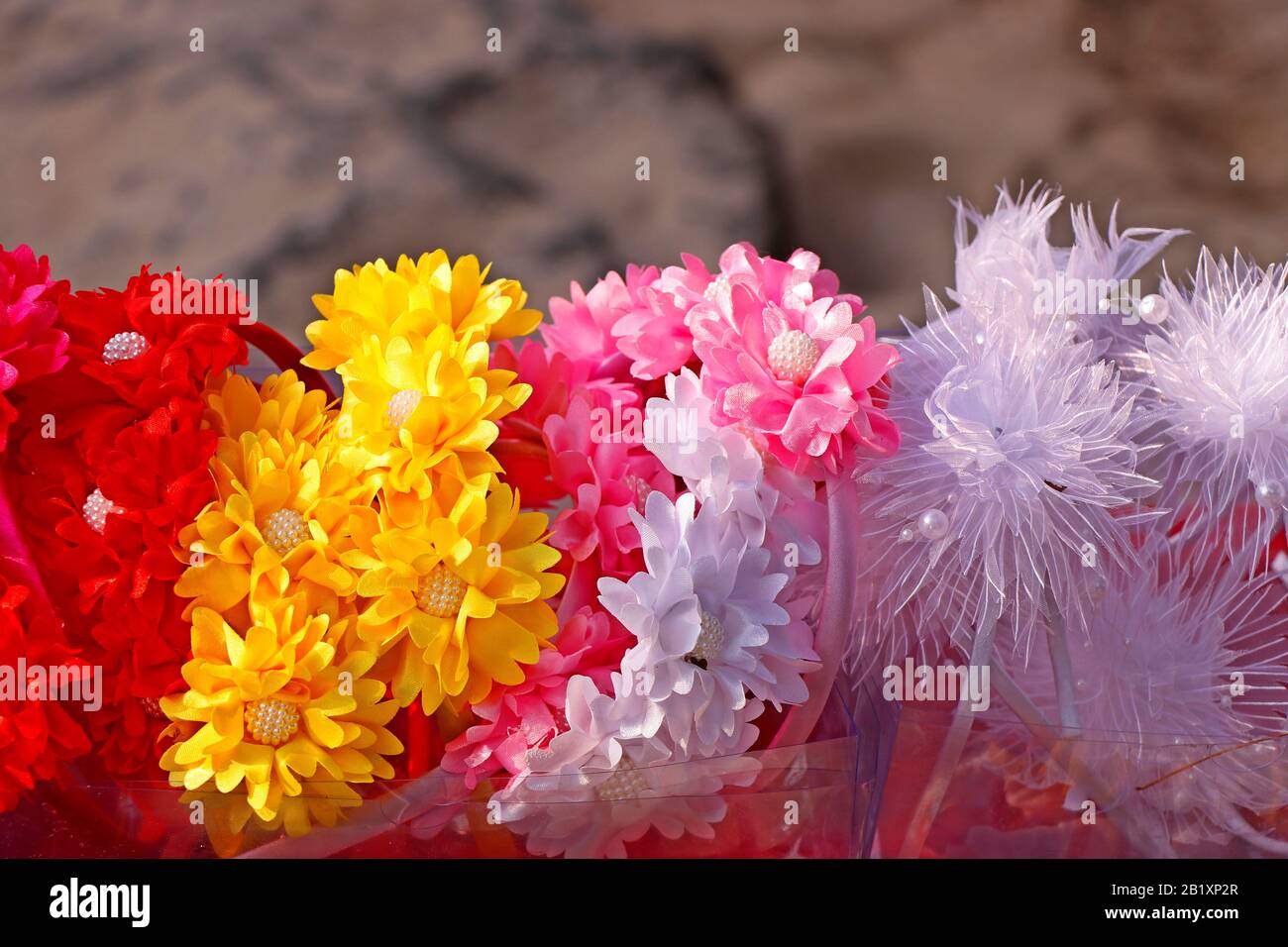 Colorful decorative artificial flowers crown in street stall for sell