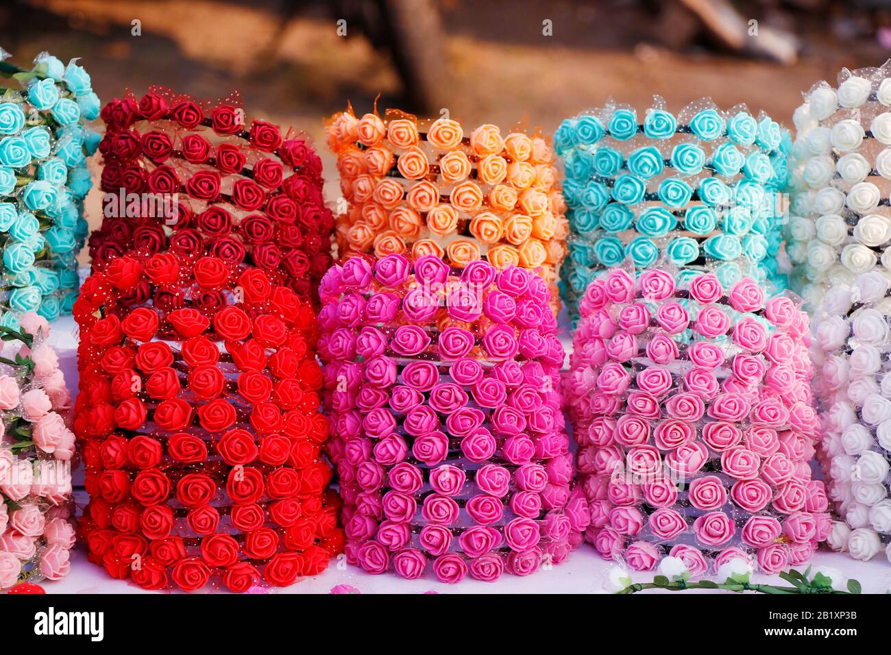 Colorful decorative artificial flowers crown in street stall for sell