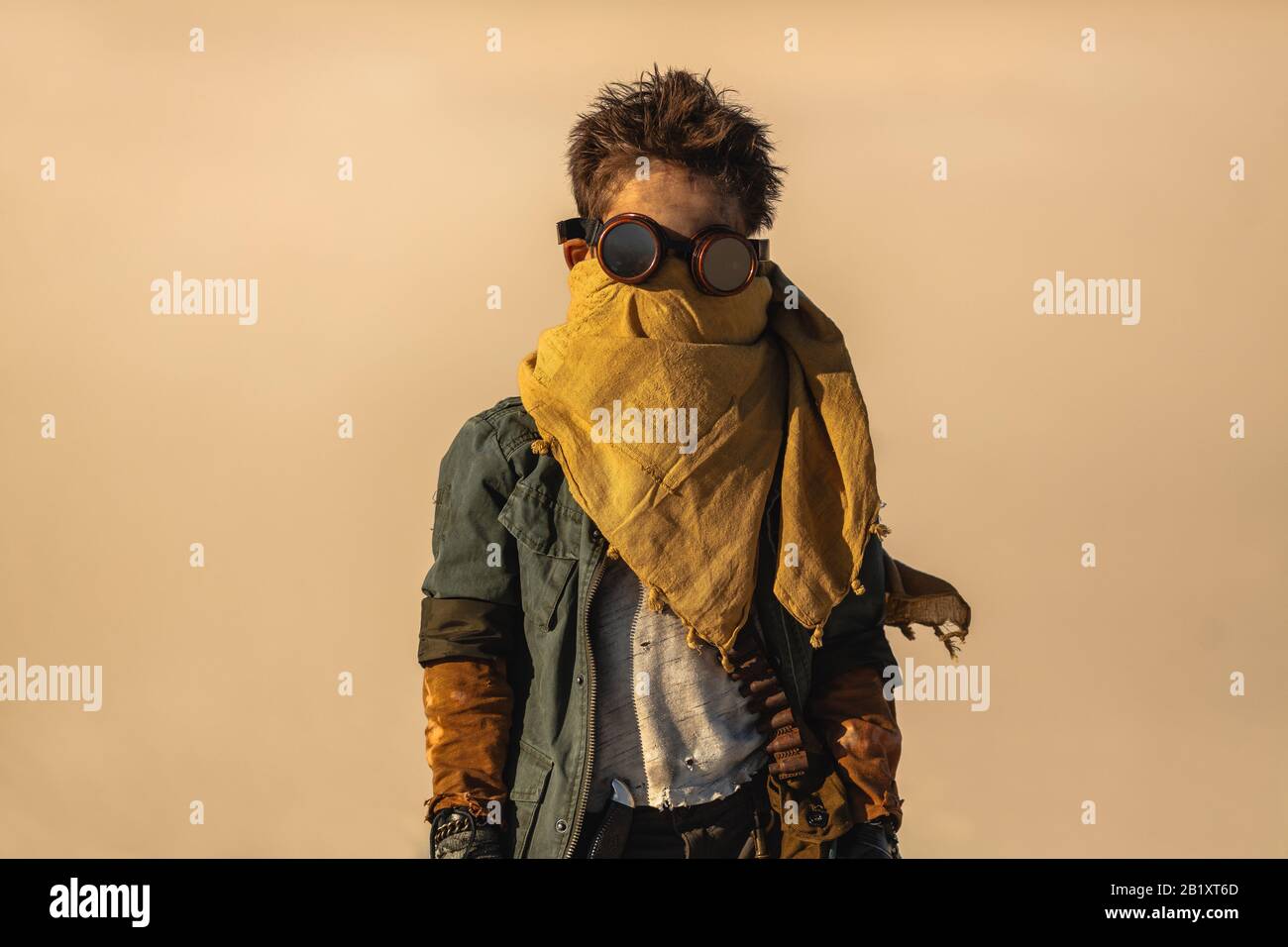Portrait of postapocalyptic boy outdoors in the desert. People in