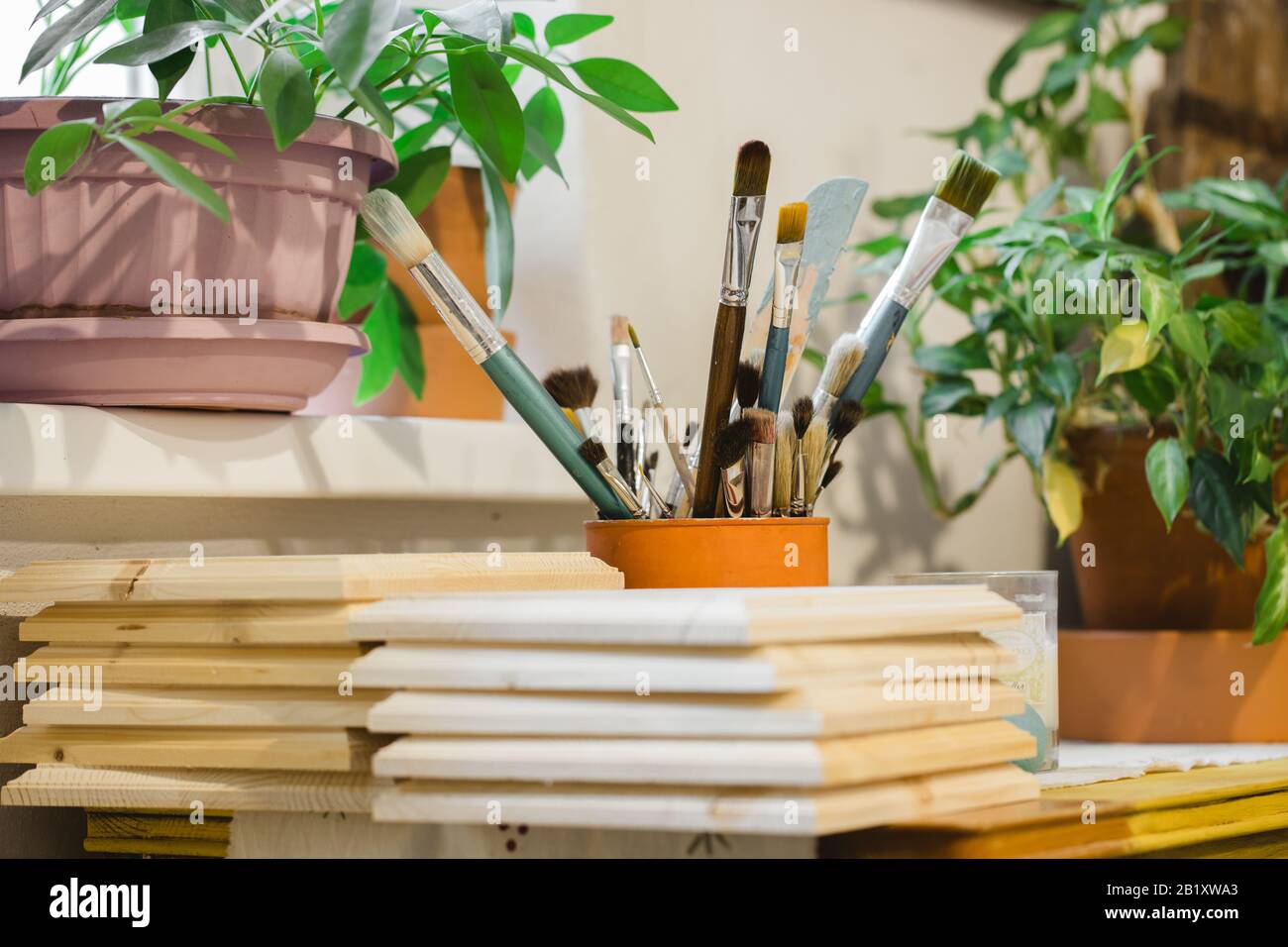colored brushes and wooden boards ready for painting Stock Photo Alamy