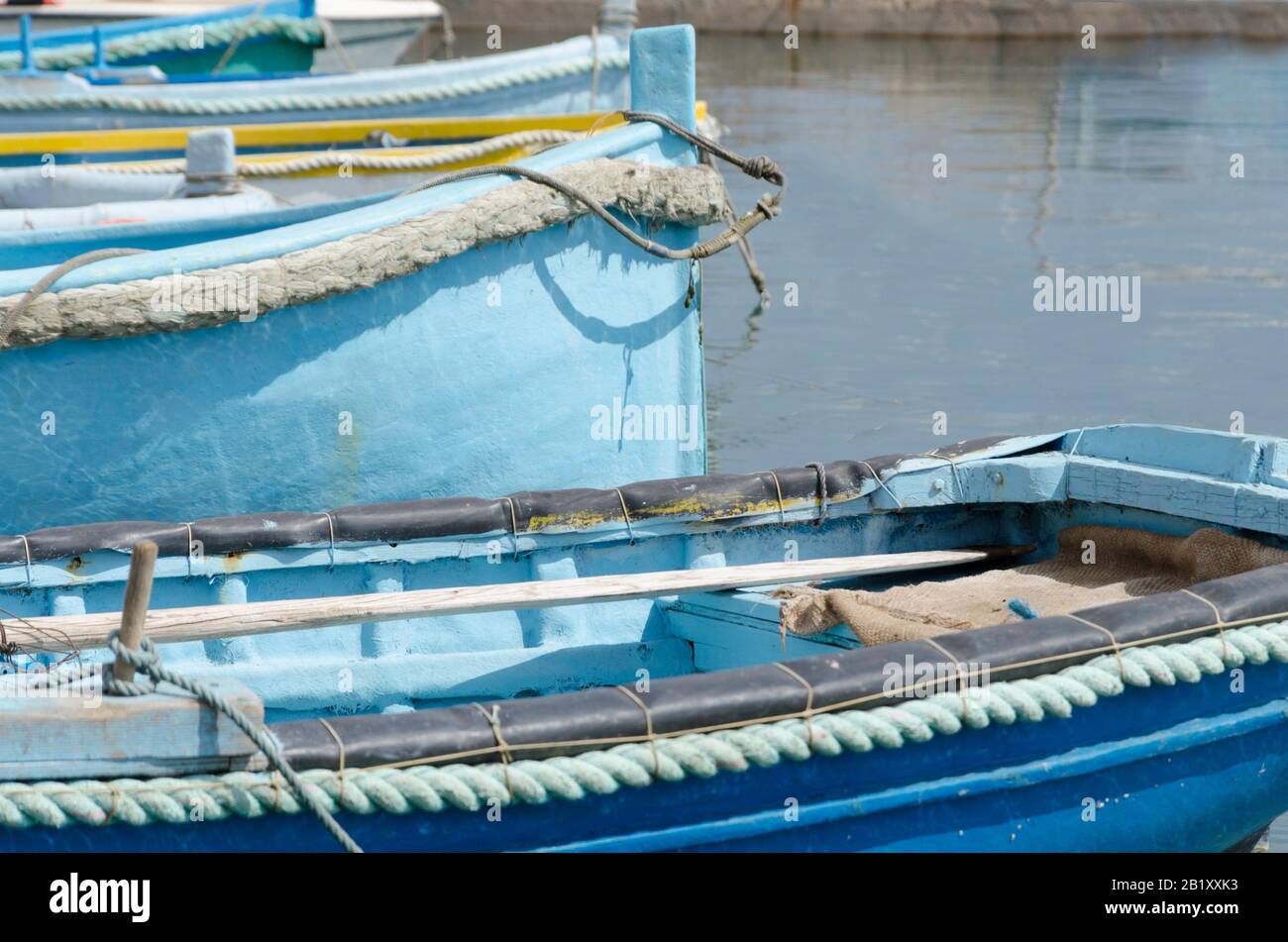 Maltese traditional colorful luzzu boats in the port of Marsaxlokk ...