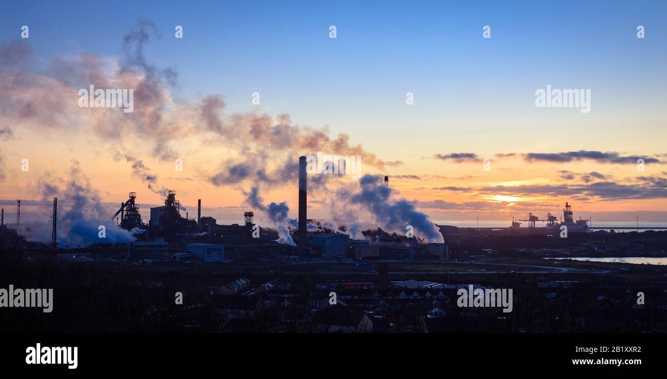 Overview of Port Talbot steel works emitting clouds of steam in the evening light Port Talbot Swansea Glamorgan Wales Stock Photo