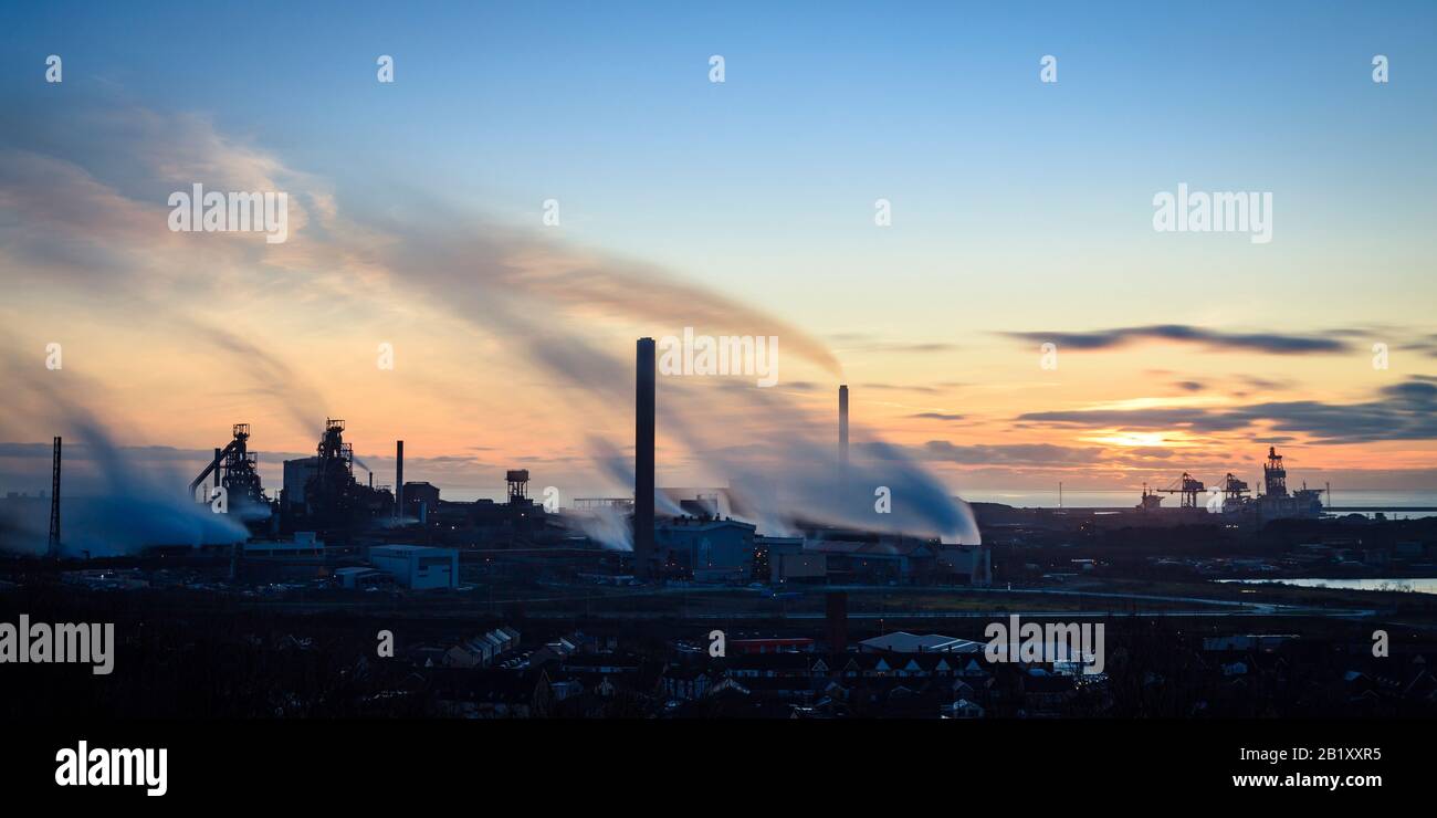 Overview of Port Talbot steel works emitting clouds of steam in the evening light Port Talbot Swansea Glamorgan Wales Stock Photo