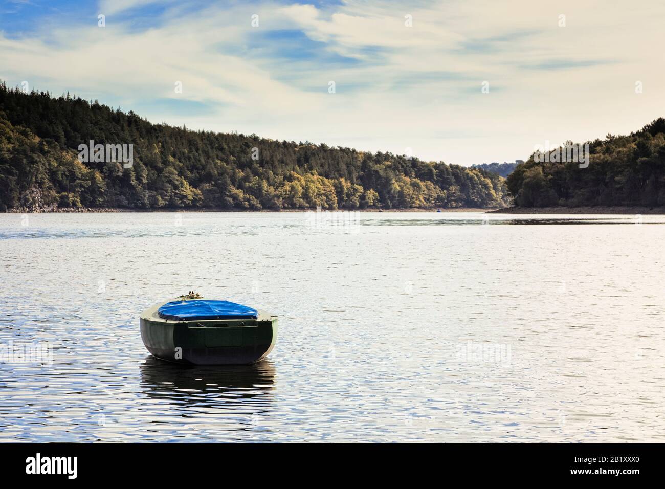 Small boat anchored in the Lac de Guerlédan, Morbihan, Brittany, France, Europe Stock Photo