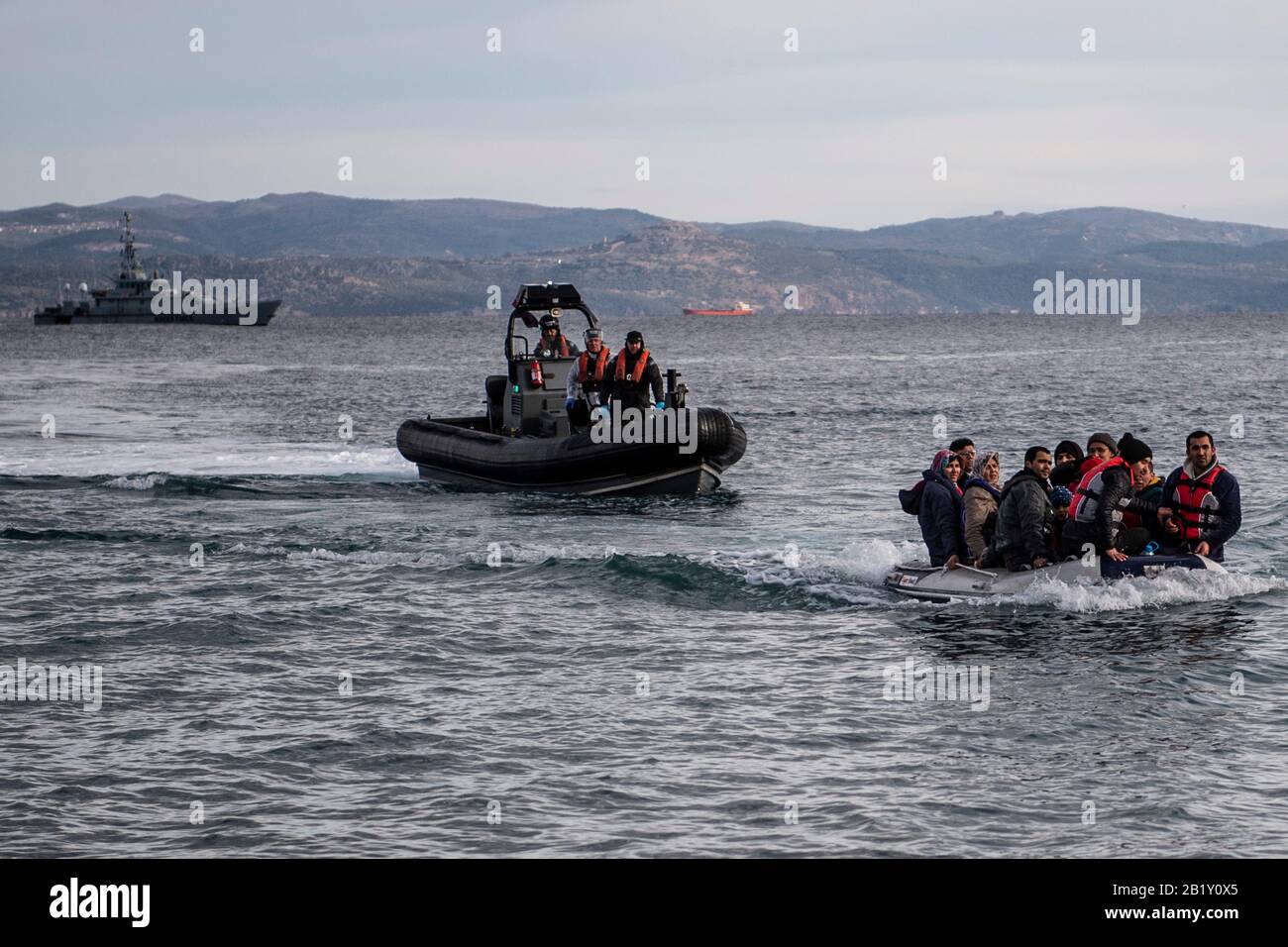 Lesbos, Greece. 28th Feb, 2020. 28 February 2020, Greece, Lesbos: A boat with 15 Afghan refugees, 5 children, 3 women and 7 men, arrives on the Greek island of Lesbos, next to the patrol boat of the British border troops HMC Valiant (background). Credit: Angelos Tzortzinis/dpa Credit: Angelos Tzortzinis/dpa/Alamy Live News Stock Photo