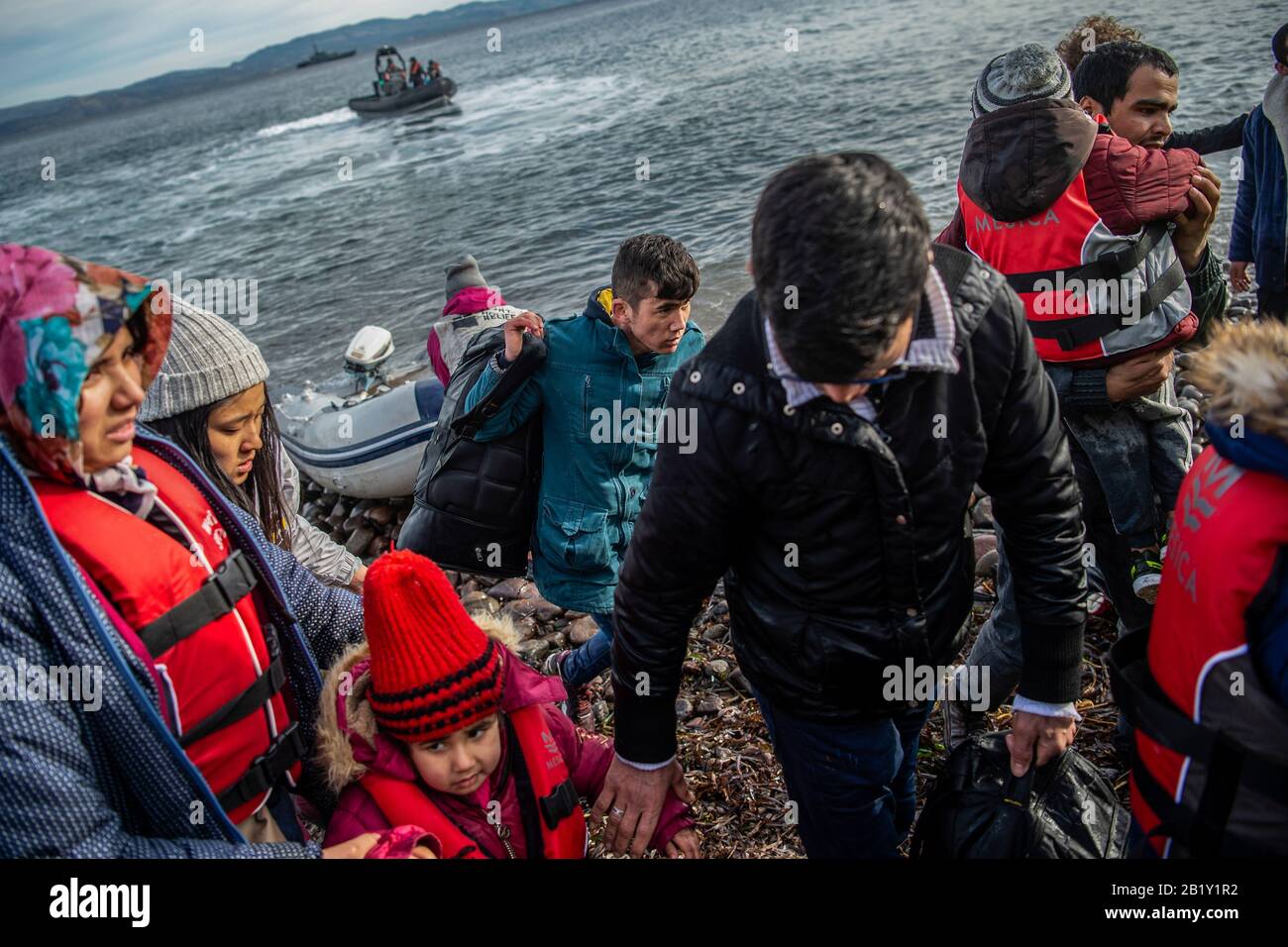 Lesbos, Greece. 28th Feb, 2020. A boat with 15 Afghan refugees, five children, three women and seven men, arrives on the Greek island of Lesbos, in front of the patrol boat of the British border troops HMC Valiant, which is part of the Frontex mission. According to the state news agency Anadolu, a spokesman for the Turkish ruling party AKP barely concealed his threat to open the borders to the refugees in the country. Credit: Angelos Tzortzinis/dpa/Alamy Live News Stock Photo