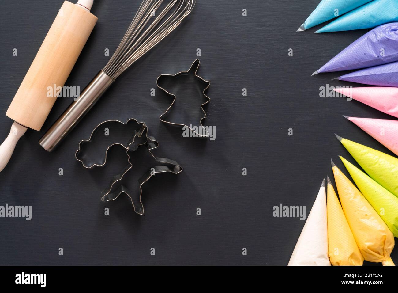 Flat lay. Variety of colors of royal icing in plastic piping bags Stock