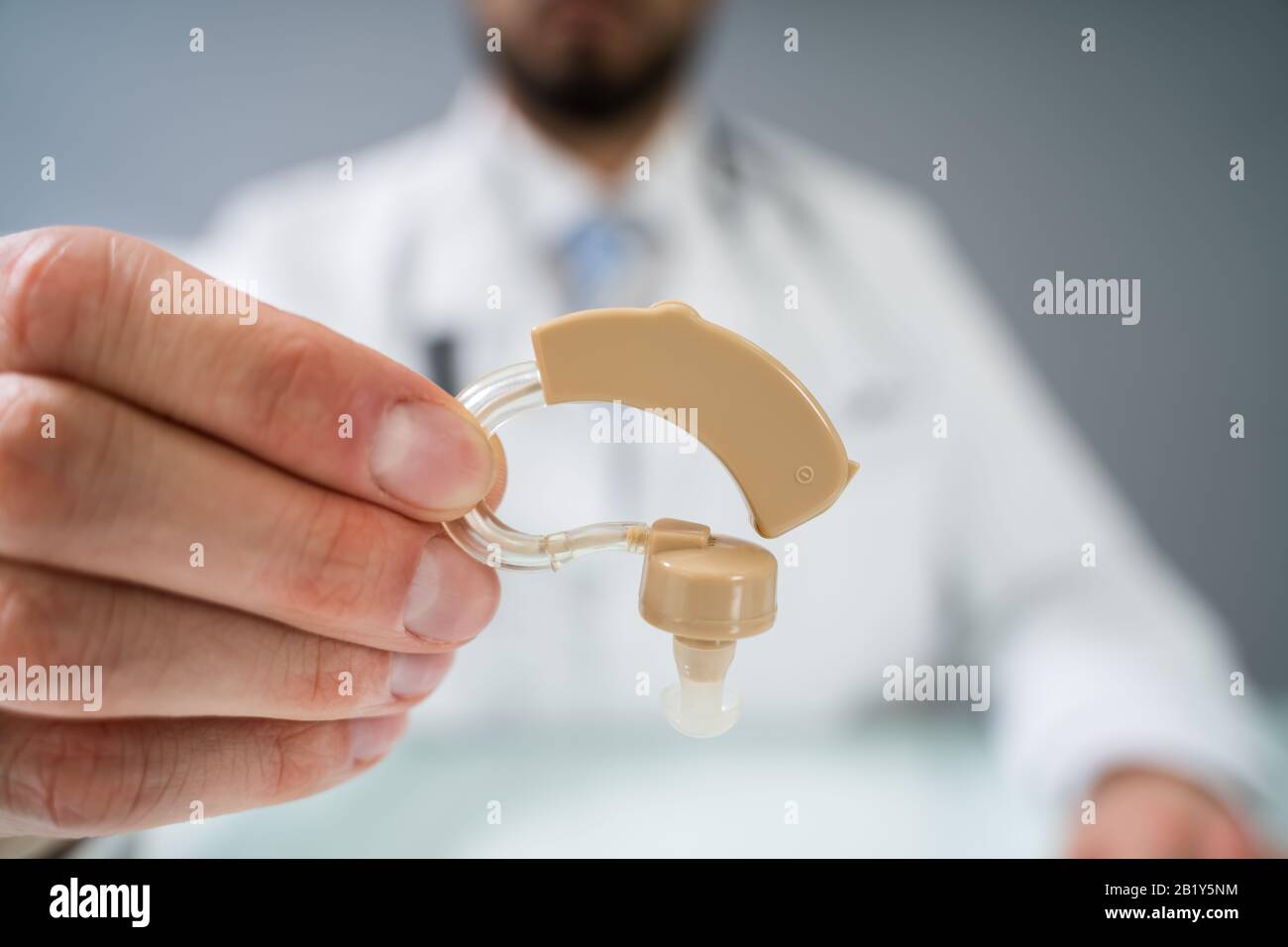 Doctor Holding Hearing Aid Device In Clinic Stock Photo Alamy