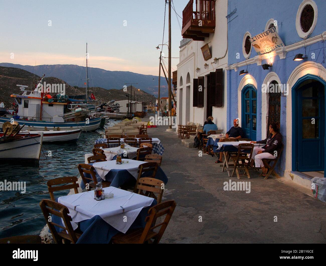 Evening mood at Meis island, also known as Kastellorizo, harbour restaurant on Meis island, Greece Stock Photo