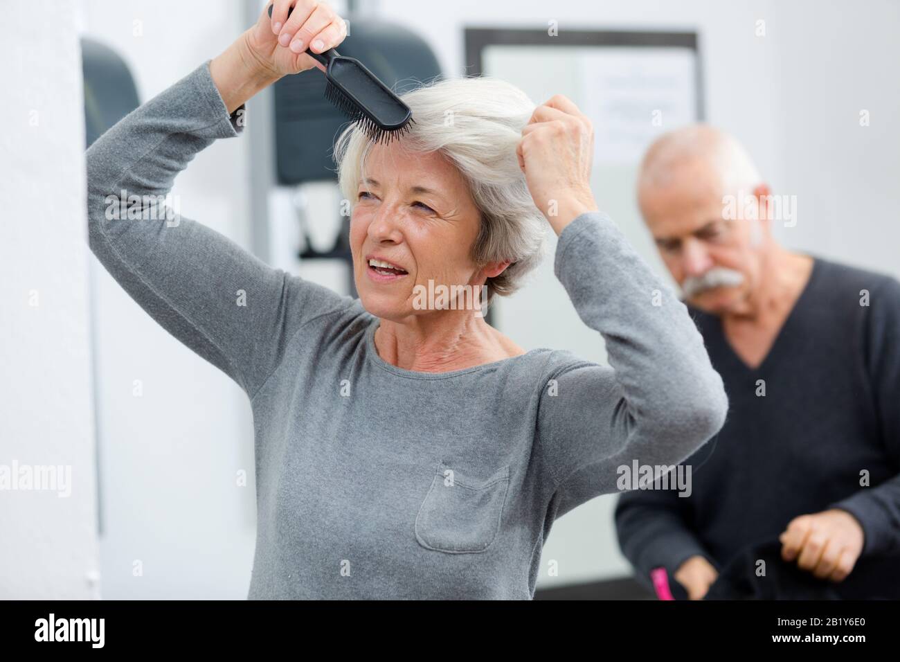 portrait of elderly woman brushing hair Stock Photo