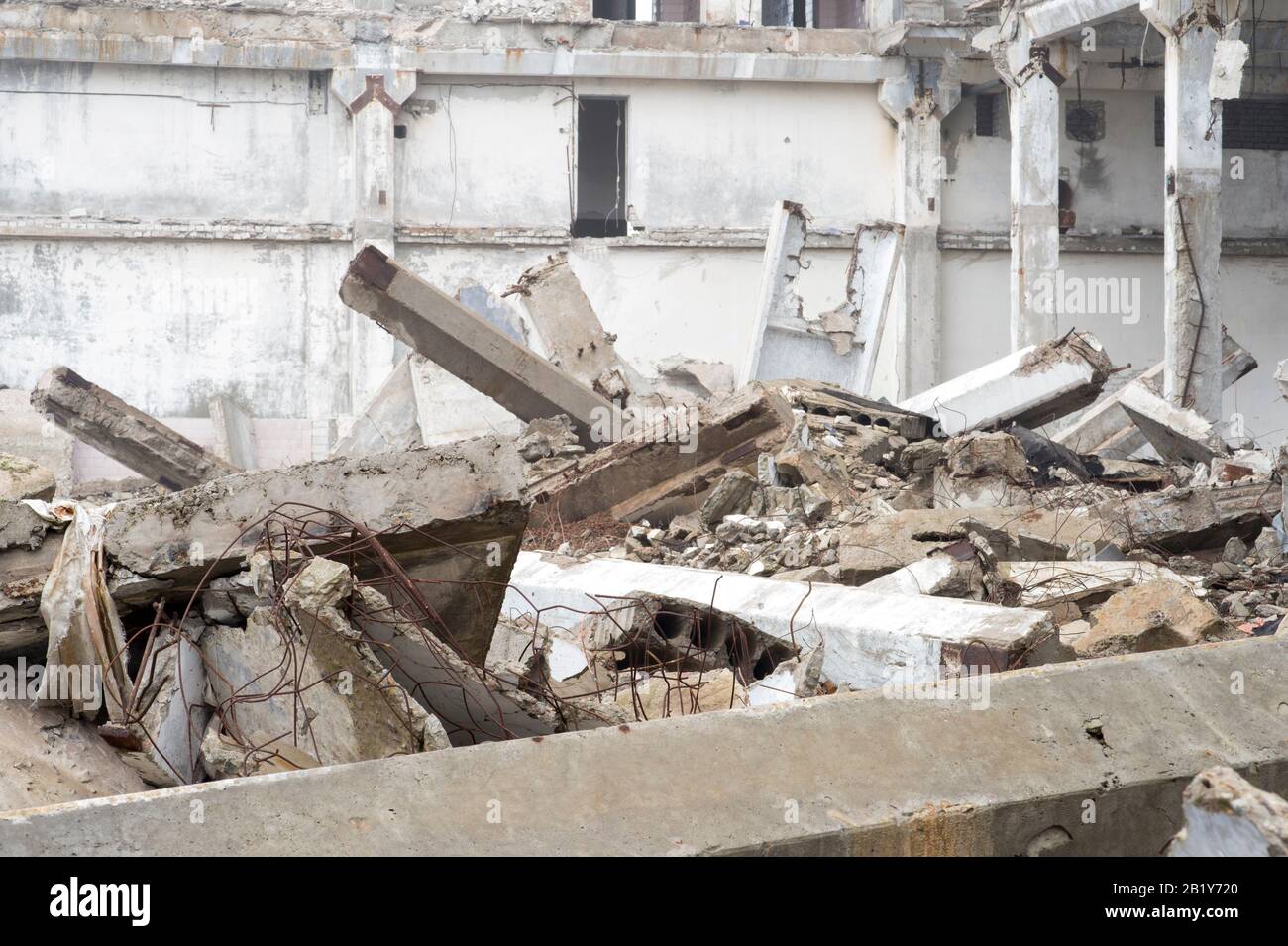 The remains of a large building destroyed in a foggy haze. Concrete ...